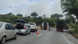 Caminh&atilde;o carregado com batatas tomba na BR-381, em Oliveira; motorista fica ferido