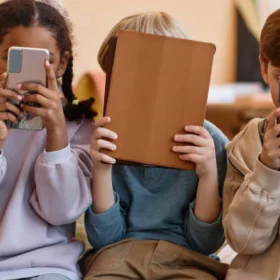 Crianças brincando ao ar livre durante as férias escolares para reduzir o tempo de telas.